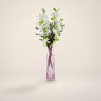 White blossom and berry artificial arrangement in tall pink glass vase