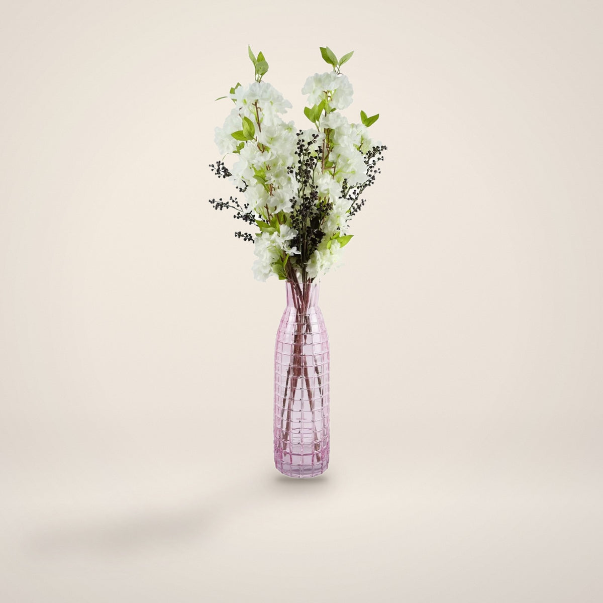 White blossom and berry artificial arrangement in tall pink glass vase