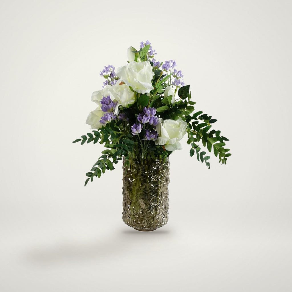 White rose and purple starflower arrangement in glass vase